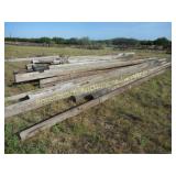 LARGE PILE OF TELEPHONE POLES