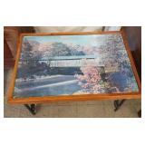 Wrought iron table with covered bridge top