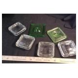 6 glass lids: 2 green Depression glass, 4 criss