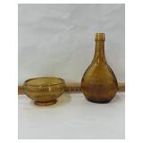 A weaken glass company bottle and a cracked g