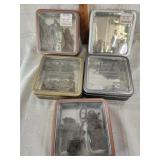5 metal containers of letters