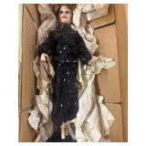 Porcelain Lucille ball doll on a black sequin