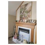 Items on fireplace: figurines,  paintings, doll,
