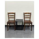 Two wooden chairs in a small table