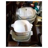 7 Corning ware dishes with 4 lids