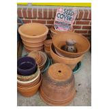 Approximately 20 terra cotta flower pots