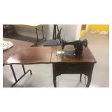 Vintage sewing machine in oak cabinet