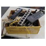 Box of surge protectors and extention cords