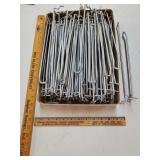 Flat of silver peg hook holders