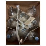 Lot of 8 gallon glass jugs without lids or pumps.