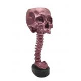 Resin Crafted Planter Of A skull sitting atop of a