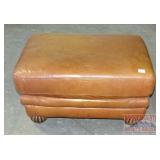 Leather Upholstered Ottoman W/ Carved Feet.