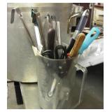 Pitcher full of ladles and misc utensils