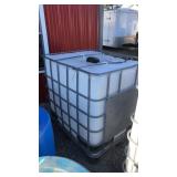 Large water tank with valve and metal cage