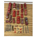 A set of red toys, trucks, and accessories