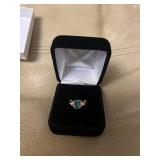 ring in box with light blue gem