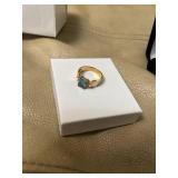 ring in box with light blue gem