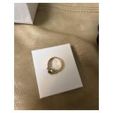 ring in box with light blue gem