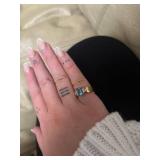 ring in box with light blue gem