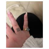 ring in box with light blue gem