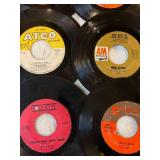 45 rpm records featuring Association, Bee Gees, Herb Albert, and more