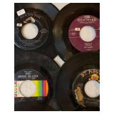 45 rpm records featuring Elvis, Bill Haley, Happenings, Stevie Wonder and more