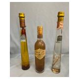 Chili oil, champagne vinegar, and thyme infused vinegar in decorative bottles