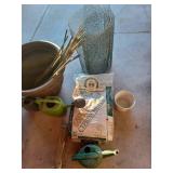 Large plastic pot, watering cans and mulch