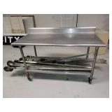 Stainless Steel Table with Backsplash on Casters (CONTENTS OF TABLE NOT INCLUDED)
