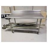 Stainless Steel Table with Backsplash on Casters (CONTENTS OF TABLE NOT INCLUDED)