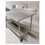 Stainless Steel Table with Backsplash on Casters (CONTENTS OF TABLE NOT INCLUDED)