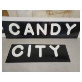 Black Background White Lettering Candy City Signs