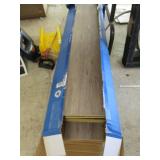 Open box of grey hardwood look flooring