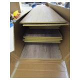 Open box of grey hardwood look flooring
