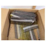Open box of magnum pro 21 3" x .131 diamond point strip nails