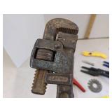 Pipe wrench, box opener, wire cable stripper & nail guides
