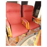 2 padded arm chairs on wheels