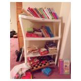 SHELF FULL OF BOOKS AND GAMES