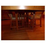 TABLE W/4 LEATHER CHAIRS ON WHEELS