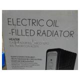 Electric oil filled 1500 watt radiator heater, new in box.
