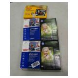 5 boxes of different brands of photo paper.