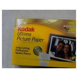 5 boxes of different brands of photo paper.