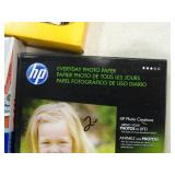 5 boxes of different brands of photo paper.