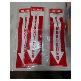 Multiple fire extinguisher signs, exit sign, and caution sign