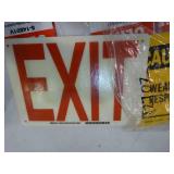 Multiple fire extinguisher signs, exit sign, and caution sign