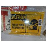 Multiple fire extinguisher signs, exit sign, and caution sign