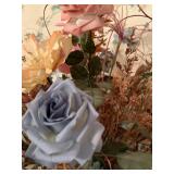 Artificial flower arrangement in brass pot