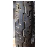 Used Harley Davidson Dunlop D401F 100/90-19 M/C 57H Front Motorcycle Tire mounted on a spoked chrome rim w/brake plates