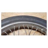Used CS Hi-Max 100/90-19 57H Front Motorcycle Tire mounted on a spoked chrome rim w/brake plate