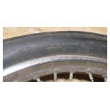 Used CS Hi-Max 100/90-19 57H Front Motorcycle Tire mounted on a spoked chrome rim w/brake plate